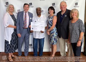 Donnie Williams Foundation members with big check