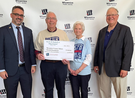 Chip Dashiell and his wife Ruby donating money for the Library